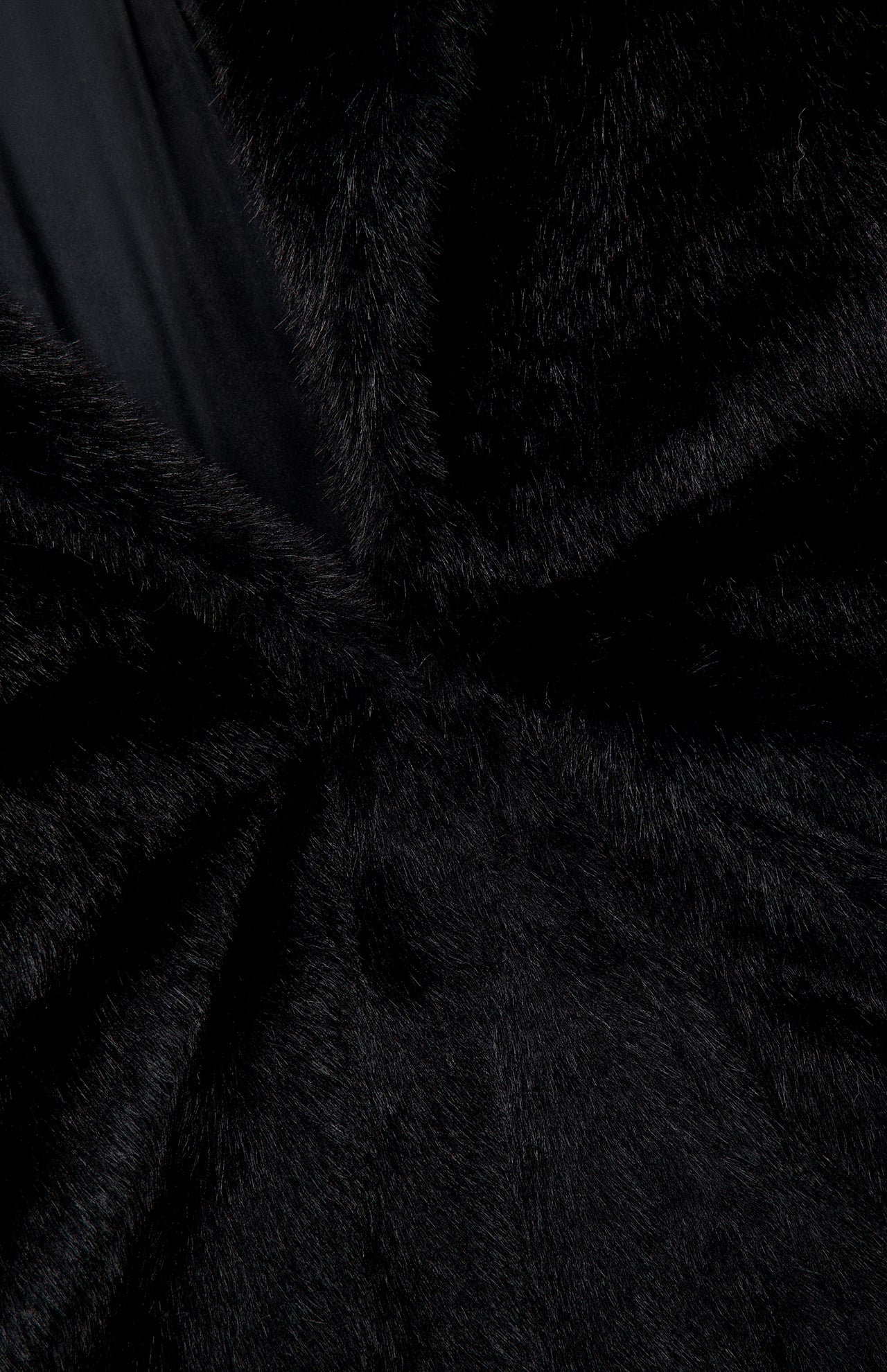Close-up of the Auter Mink Cocoon Coat, an oversized black mink coat featuring a smooth dark lapel.