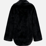 Back view of The Mink Cocoon Coat by Auter, an oversized, black, animal-free mink, knee-length coat with long sleeves.