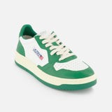 The AUTRY Medalist Low Bicolor Sneakers feature a green and white design with white laces, a perforated toe, side logo patch with text and flag, and a cream platform sole for a sporty, fresh look.