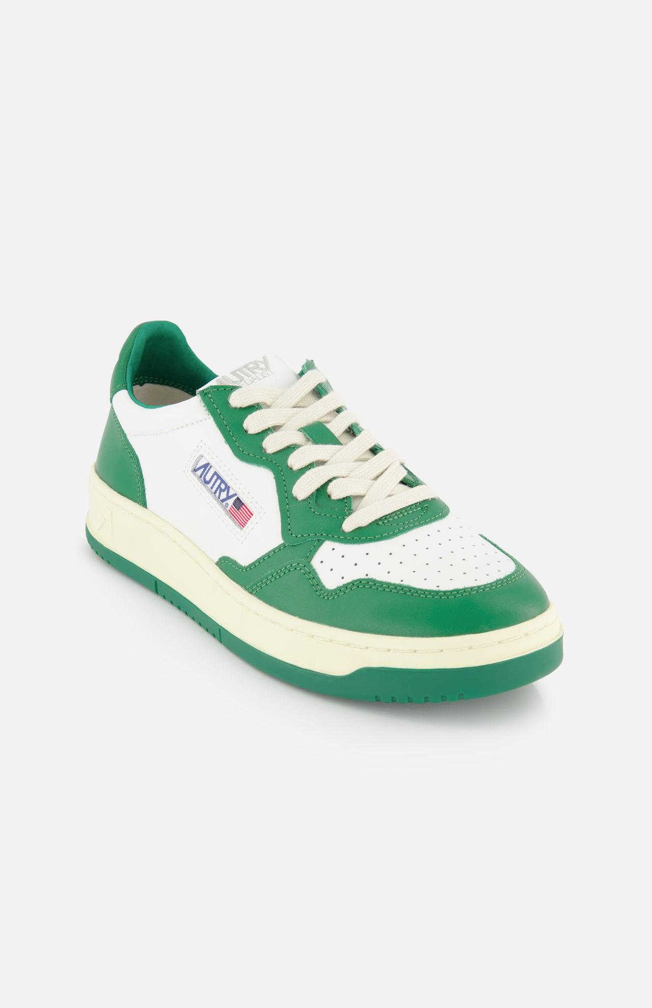 The AUTRY Medalist Low Bicolor Sneakers feature a green and white design with white laces, a perforated toe, side logo patch with text and flag, and a cream platform sole for a sporty, fresh look.
