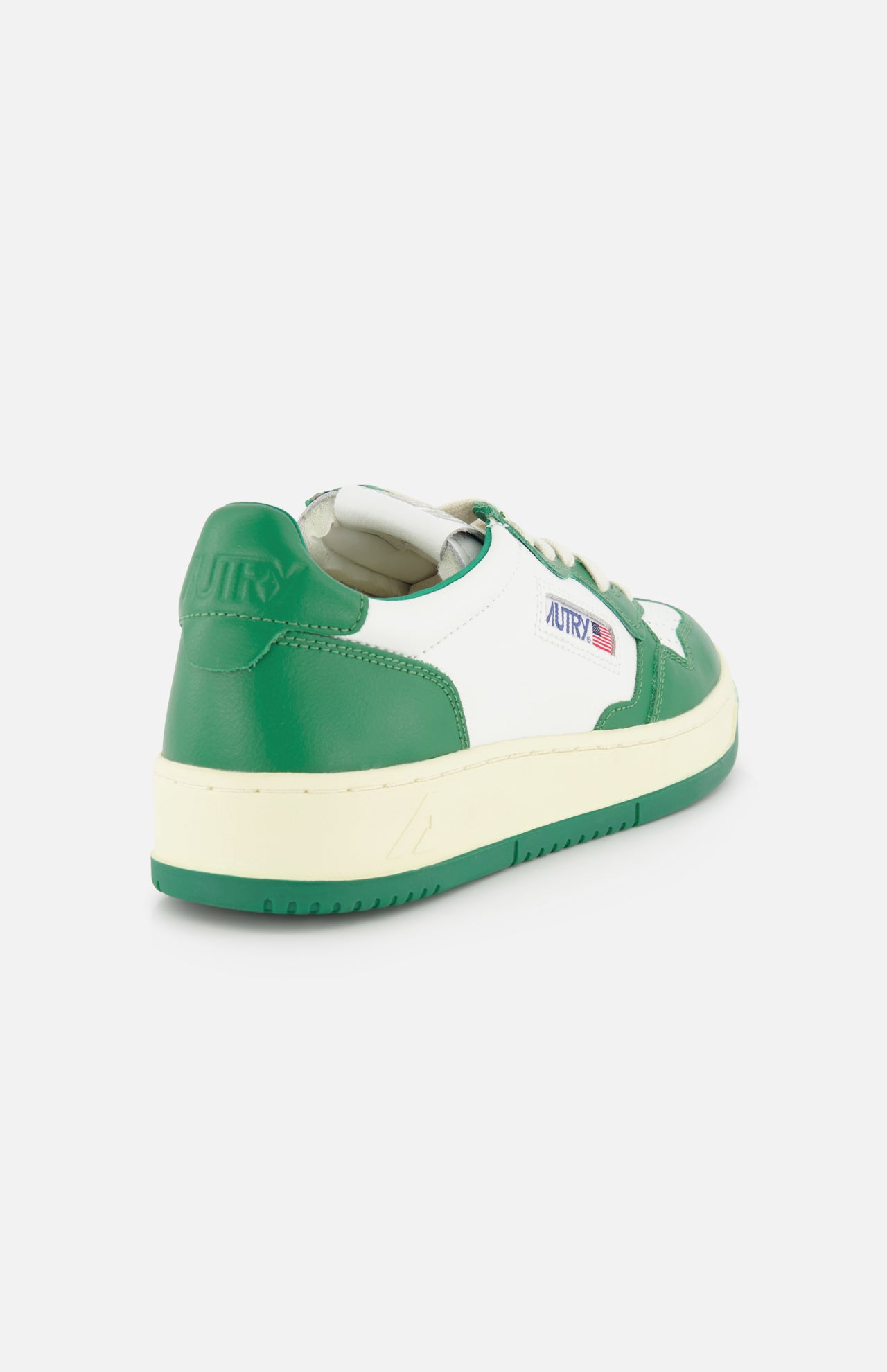 The AUTRY Medalist Low Bicolor Sneakers are green and white low-tops with a retro design, cream-colored sole, and side Autry logo, shown from the rear on a white background.