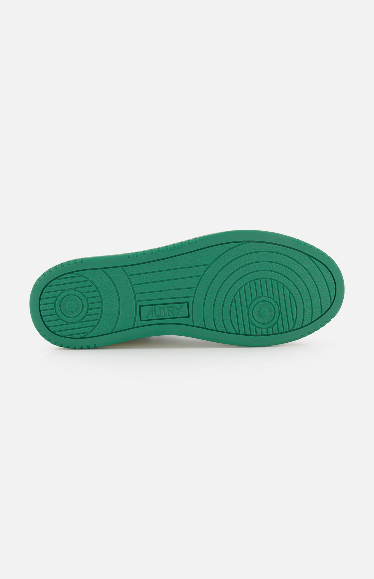 The Medalist Low Bicolor Sneakers by AUTRY feature a green platform sole with circular and linear tread patterns and the AUTRY logo embossed at the center, set against a plain white background.