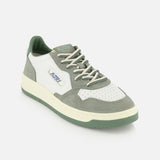 The AUTRY Medalist Low Leather Suede Sneaker features a white leather upper with perforated toe, light gray and green suede panels, green platform sole, white laces, and classic 1980s-inspired AUTRY branding on the side and tongue.