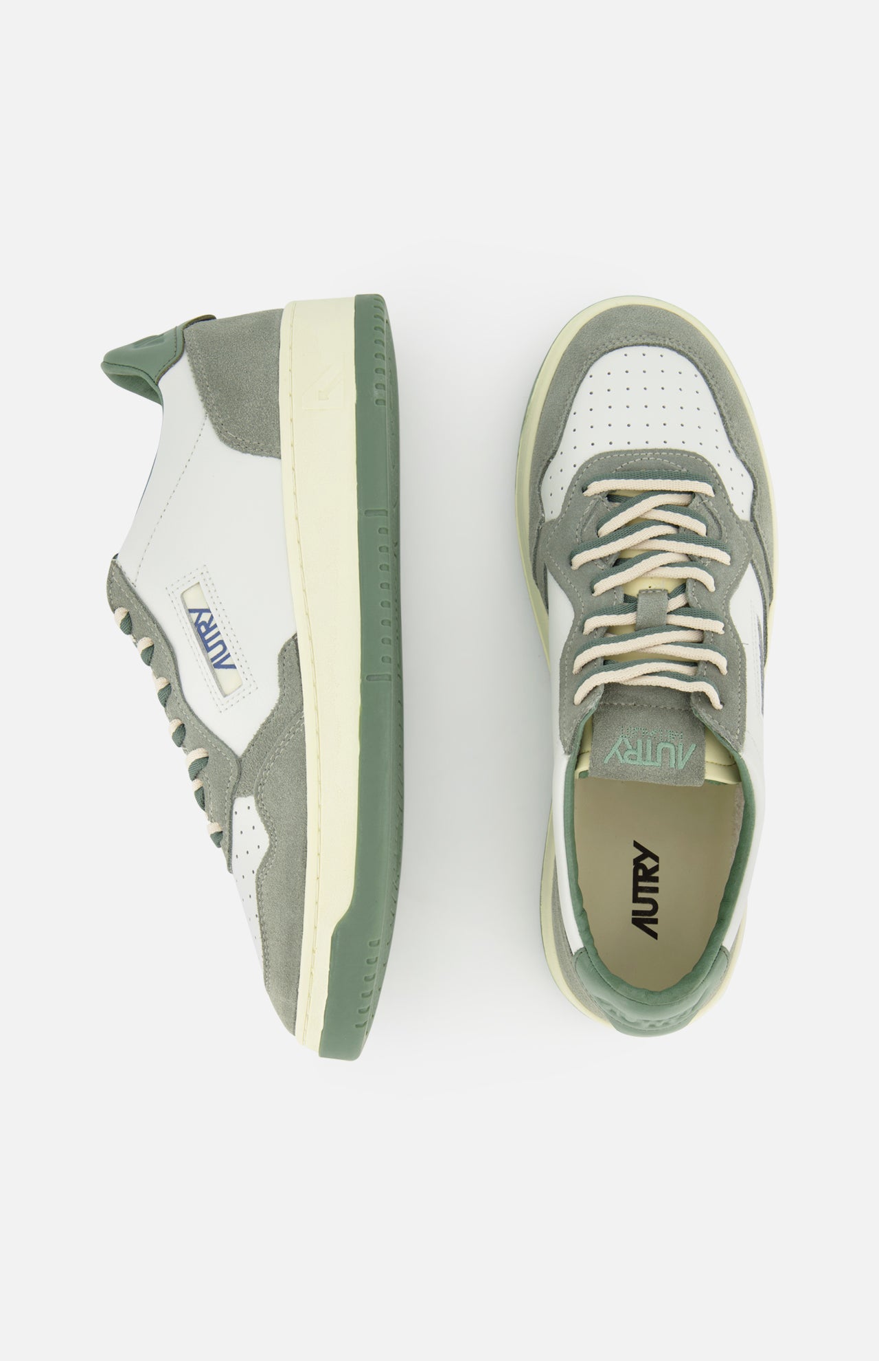 The AUTRY Medalist Low Leather Suede Sneaker in white and sage green features suede and leather panels, perforated toe area, cream laces, and a green rubber sole—styles inspired by 1980s tennis shoes, shown from side and top views.