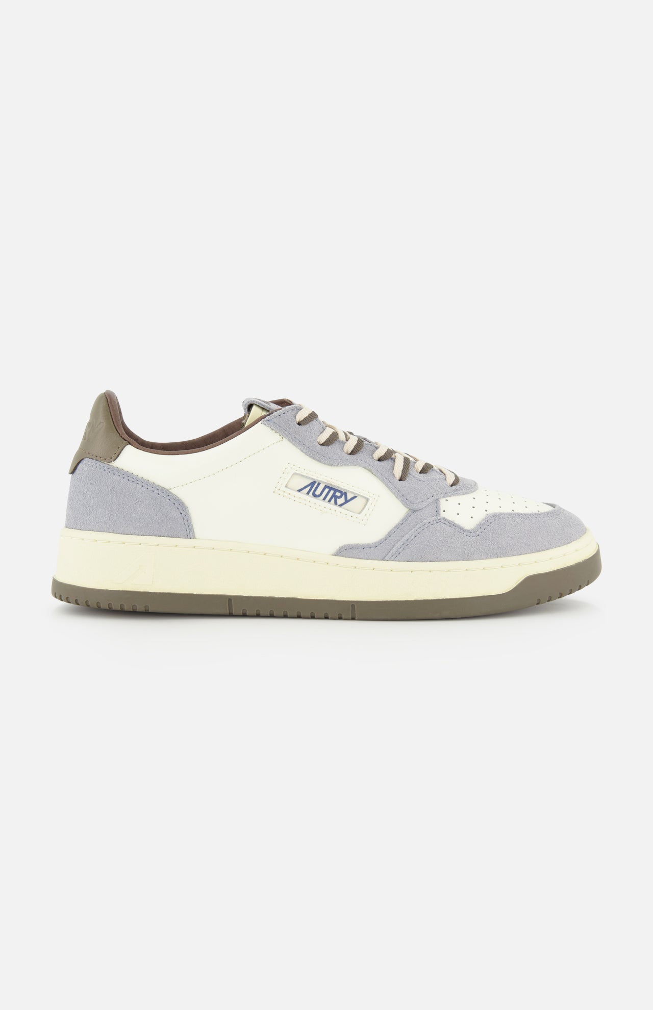 The AUTRY Medalist Low Man Leather Suede Sneaker is a white and gray low-top inspired by 1980s tennis shoes, crafted with suede and leather panels, gray laces, and the signature Autry logo on the side. The sneaker is finished with a cream sole, brown heel tab, and classic retro styling throughout.