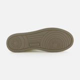 The image features the sole of the AUTRY Medalist Low Man Leather Suede Sneaker in beige, displaying various textured patterns and an AUTRY embossing near the arch, evoking the style of classic 1980s tennis shoes.