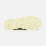 The image displays the bottom view of a single AUTRY Medalist Low Man Shearling Sneaker in beige, highlighting its circular and straight tread patterns on a platform sole, set against a white background.