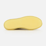 The image shows the bottom view of the AUTRY Medalist Low Man Suede Leather Sneaker, featuring a plain, light yellow sole against a white background.