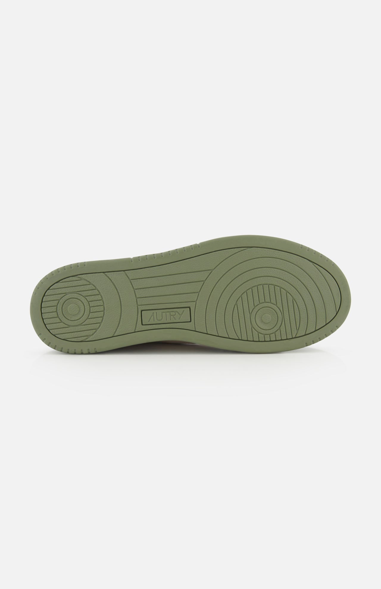 The AUTRY Medalist Low Man Suede Sneaker features an olive green sole with circular and linear tread patterns, and the AUTRY brand name embossed at the center. This low-top sneaker boasts a stylish design, displayed against a white background.