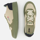 AUTRY’s Medalist Low Man Suede Sneakers in beige and olive green are displayed from the side and top, highlighting their multicolored suede and leather panel design, white laces, perforated toe box, and distinctive green rubber sole.