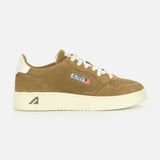 The AUTRY Medalist Low Suede Sneaker features brown suede, a cream platform sole and laces, white heel accent, side AUTRY logo with American flag patch, and classic 1980s tennis shoe inspiration. Displayed on a plain white background.