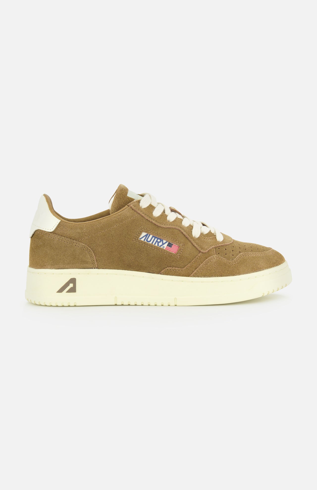The AUTRY Medalist Low Suede Sneaker features brown suede, a cream platform sole and laces, white heel accent, side AUTRY logo with American flag patch, and classic 1980s tennis shoe inspiration. Displayed on a plain white background.