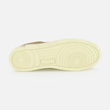 The image shows the light beige platform sole of the AUTRY Medalist Low Suede Sneaker, featuring circular and linear tread patterns, viewed from the bottom against a plain white background.