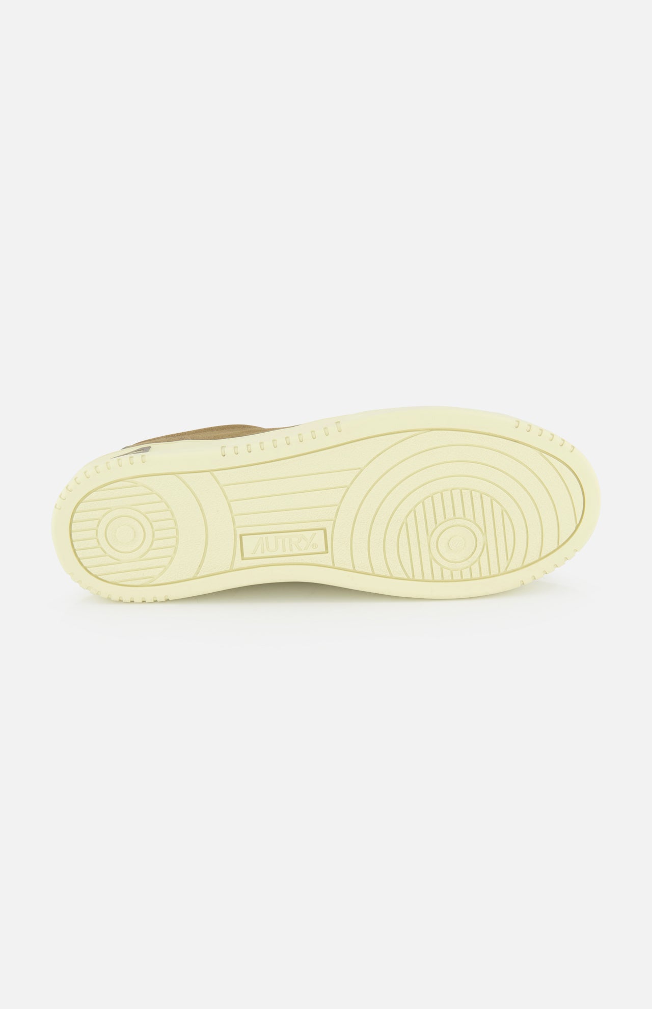 The image shows the light beige platform sole of the AUTRY Medalist Low Suede Sneaker, featuring circular and linear tread patterns, viewed from the bottom against a plain white background.
