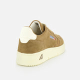 The AUTRY Medalist Low Suede Sneaker, shown from the rear on a white background, features brown suede, a cream platform sole and heel accent, and a small “ARTIST.” patch on the side.