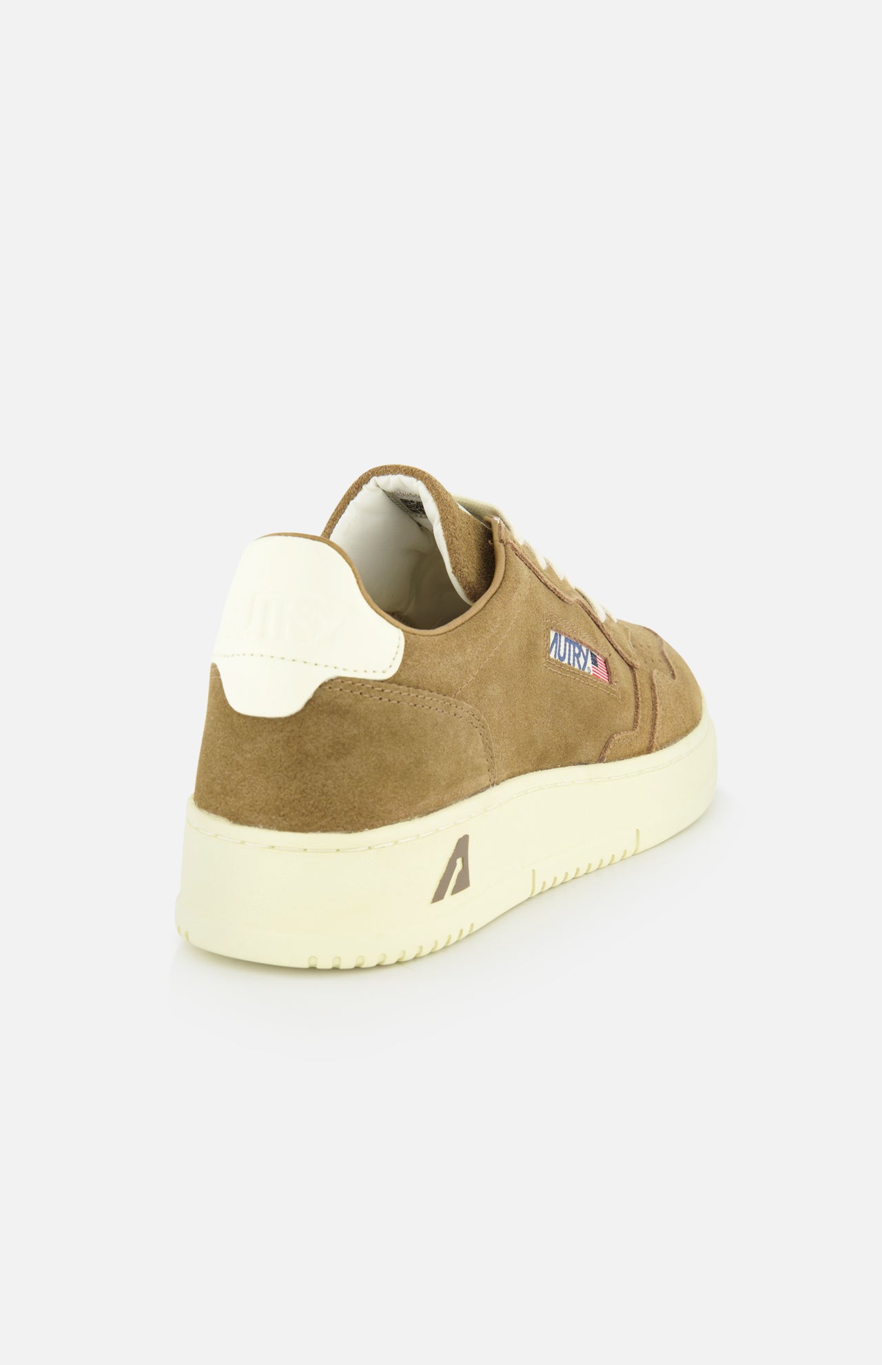 The AUTRY Medalist Low Suede Sneaker, shown from the rear on a white background, features brown suede, a cream platform sole and heel accent, and a small “ARTIST.” patch on the side.