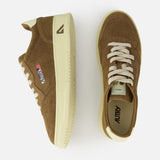 AUTRY Medalist Low Suede Sneakers in brown with cream soles and laces, shown from side and top on white. Features a stitched logo patch and retro 1980s tennis shoe-inspired design.