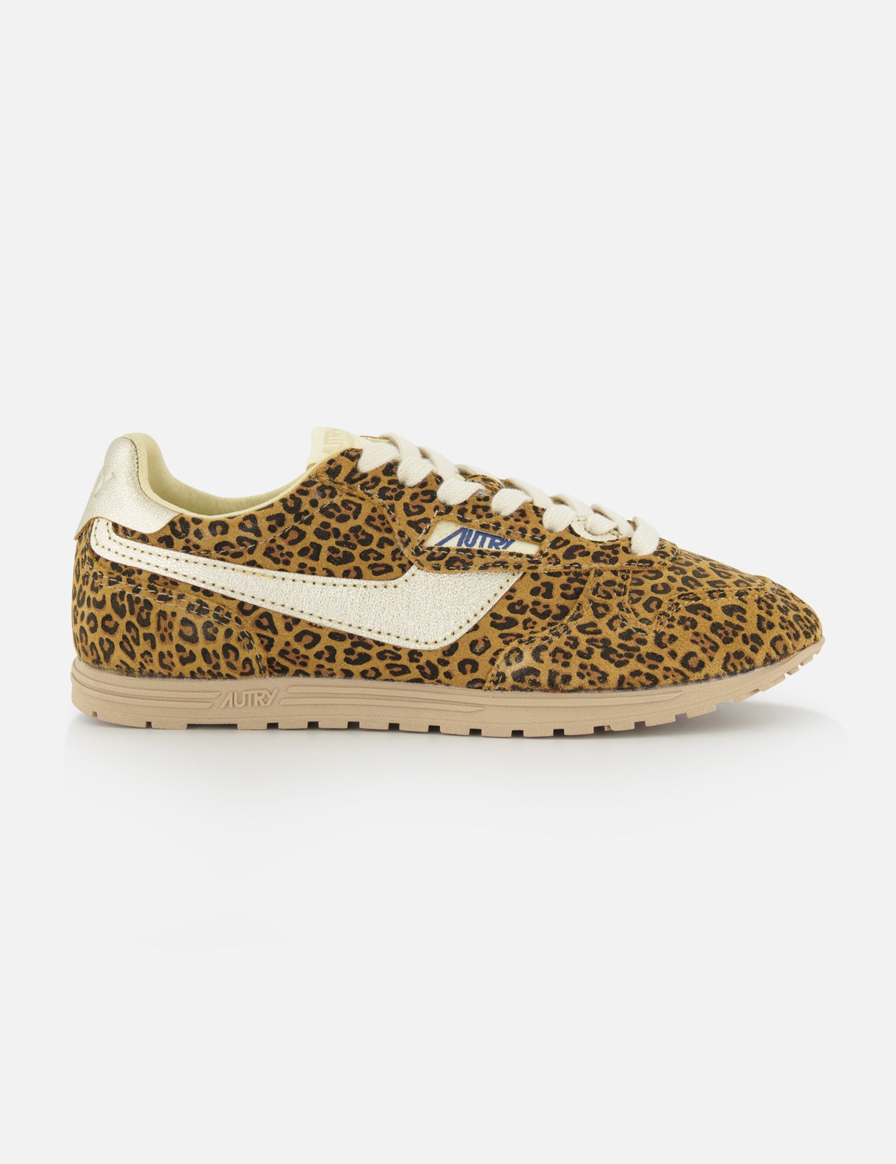 The AUTRY Windspin Leopard Low Sneaker showcases a 60s-inspired leopard print with brown and black spots, white laces, a thick beige sole, gold heel detail, and a white side stripe, set against a plain white background.