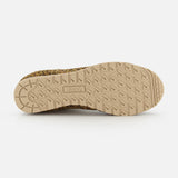 The image displays the beige rubber sole of the AUTRY Windspin Leopard Low Sneaker, showcasing a textured tread for grip. "AUTRY" is embossed at the center, while the upper edge reveals its striking leopard print design.