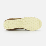 The image shows the beige, textured sole of the Autry Windspin Low Brushed Suede Sneaker with rectangular and circular grips. "AUTRY" is embossed in a rectangular section near the center.