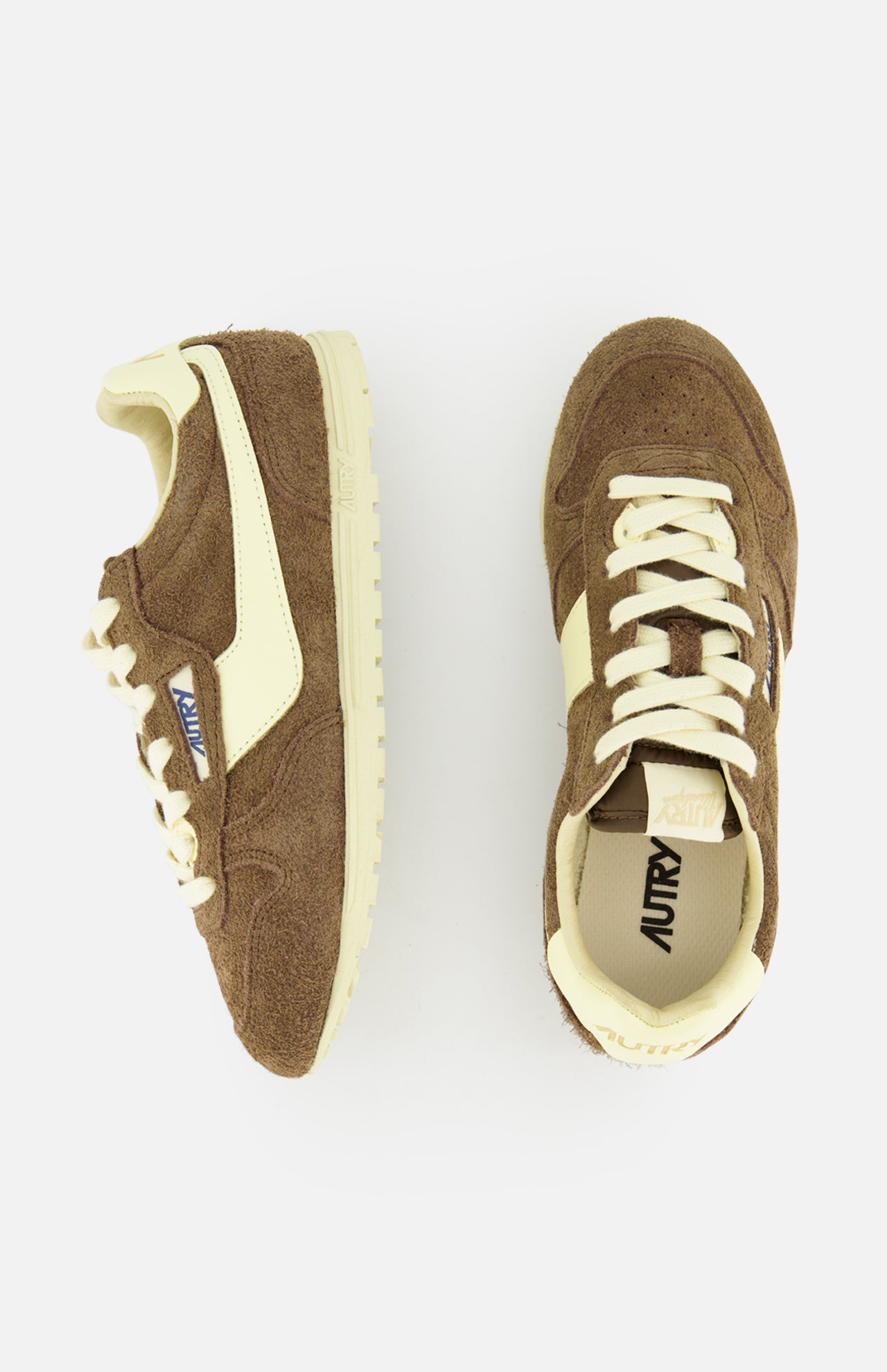 The Autry Windspin Low Brushed Suede Sneaker is shown in brown and cream, with one shoe seen from the side and one from above on a white background. Both feature white laces and vintage-inspired retro details.