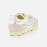 The AUTRY Windspin Low Knit Sneaker features a beige and silver design with a suede heel, mesh panels, and a cream sole, offering vintage style. Shown angled from the back on a white background.