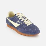 Introducing the AUTRY Windspin Low Suede Sneaker, featuring dark blue suede with a soft textured finish, cream laces, a signature white side stripe, and a brown rubber sole—capturing retro-inspired charm against a clean white backdrop.