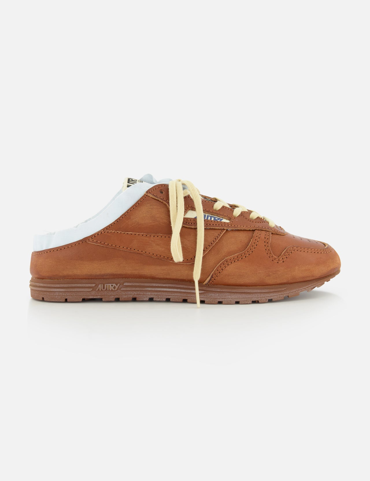The AUTRY Windspin Leather Mule Sneaker features brown leather, a white sole, yellow laces, vintage charm, and an open back—displayed on a white background.