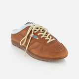 The AUTRY Windspin Leather Mule Sneaker features brown leather, cream laces, light blue lining, and a perforated toe for vintage style, showcased on a white background.