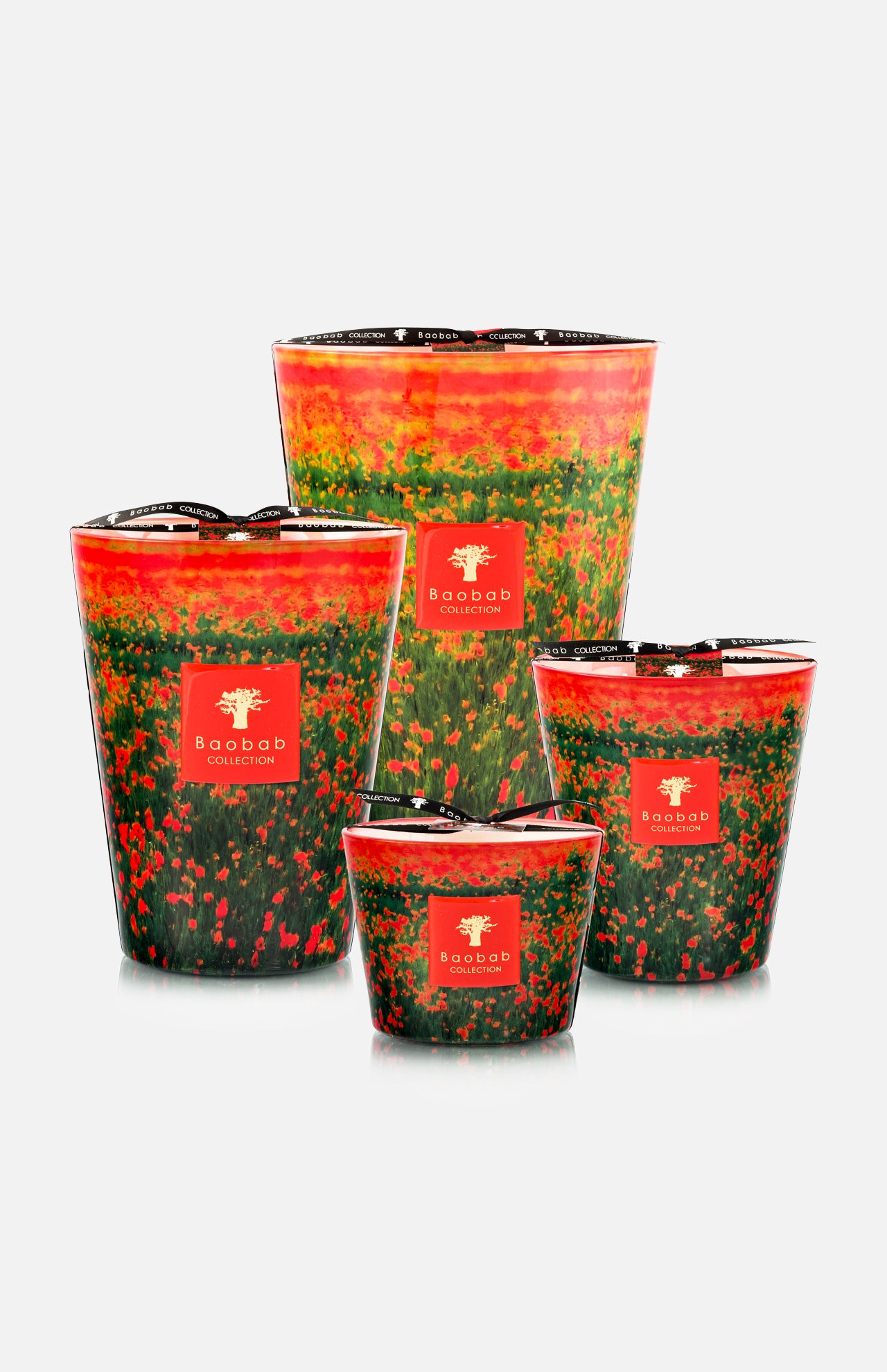 Four BAOBAB COLLECTION Arty Flowers Poppies Max 16 Candles in varying sizes, each with vibrant abstract red, green, and orange designs, feature a red logo label on the front. Hand-poured wax. Displayed against a white background.