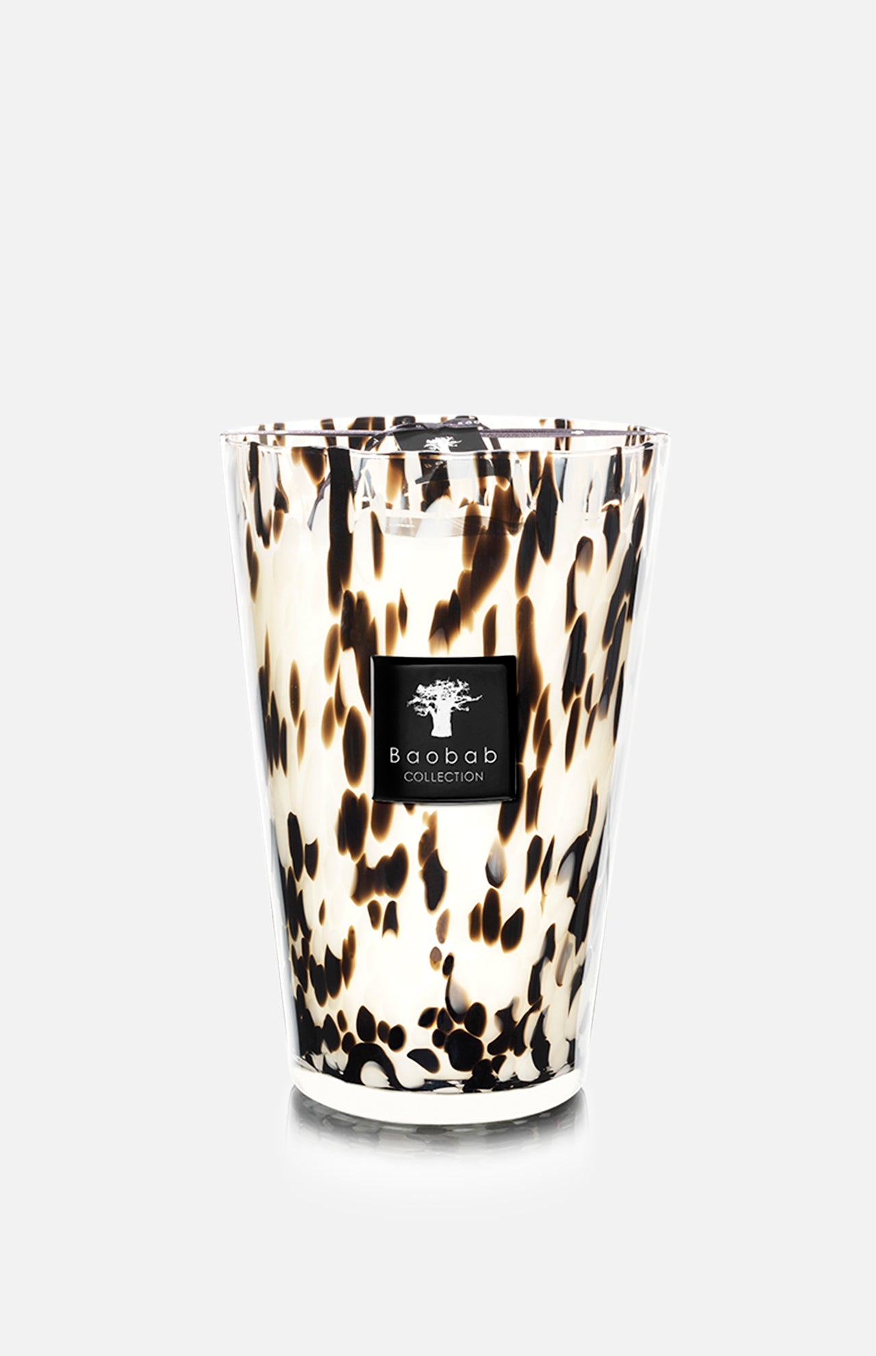 The Pearls Black MAX 35 by BAOBAB COLLECTION is a white hand-blown glass candle featuring black and brown speckles and the brand's label on the front, placed against a plain light gray background.