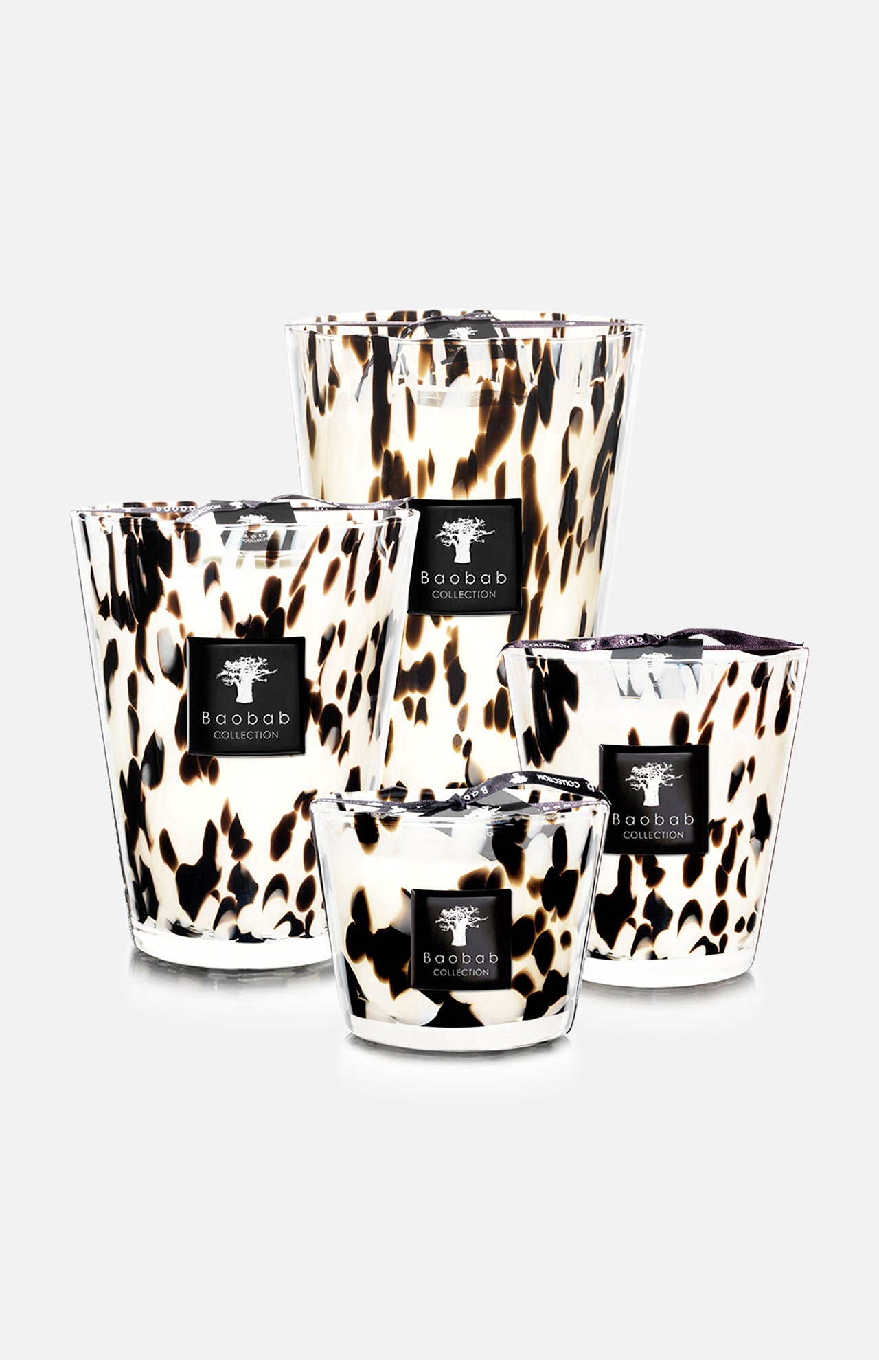 Four BAOBAB COLLECTION Pearls Black MAX 35 scented candles in hand-blown glass containers with a white and black animal print, grouped on a plain white background. Each features the brand’s logo on a black label.