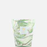 The BAOBAB COLLECTION Leaves Marius Max 16 Candle features hand-poured wax in a cup with a green and white marbled design, accented by a gold logo and label. Its artisanal style adds elegance to any space. Displayed on a plain white background.