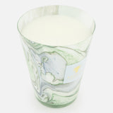 The Leaves Marius Max 24 Candle by BAOBAB COLLECTION is a large, white scented candle in a marbled glass holder with green and gray swirls, hand-poured wax inside, and a small gold-embossed label on the front against a plain white background.