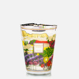 A decorative glass luxury scented candle from BAOBAB COLLECTION, the Provence Max 24 Candle features colorful floral and plant illustrations with hand-poured wax, offering an aromatic experience.