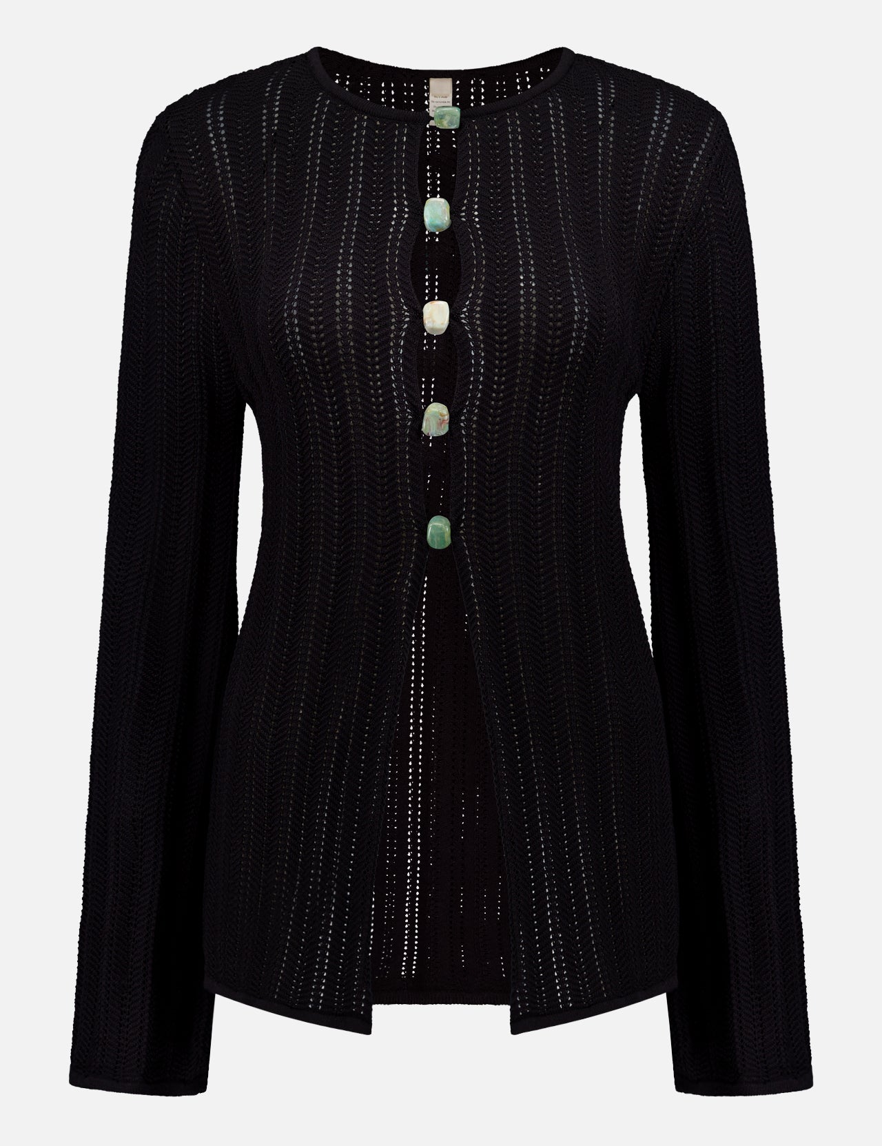 The BAOBAB Corsica Cut Out Stone Top is a lightweight black long-sleeve cardigan, featuring sheer open-knit fabric with vertical perforated stripes and five decorative green and cream buttons down the front.