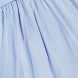 A close-up of light blue gathered pleats from the Agustina Open Back Maxi Dress by BAOBAB, highlighting its soft, flowing texture.