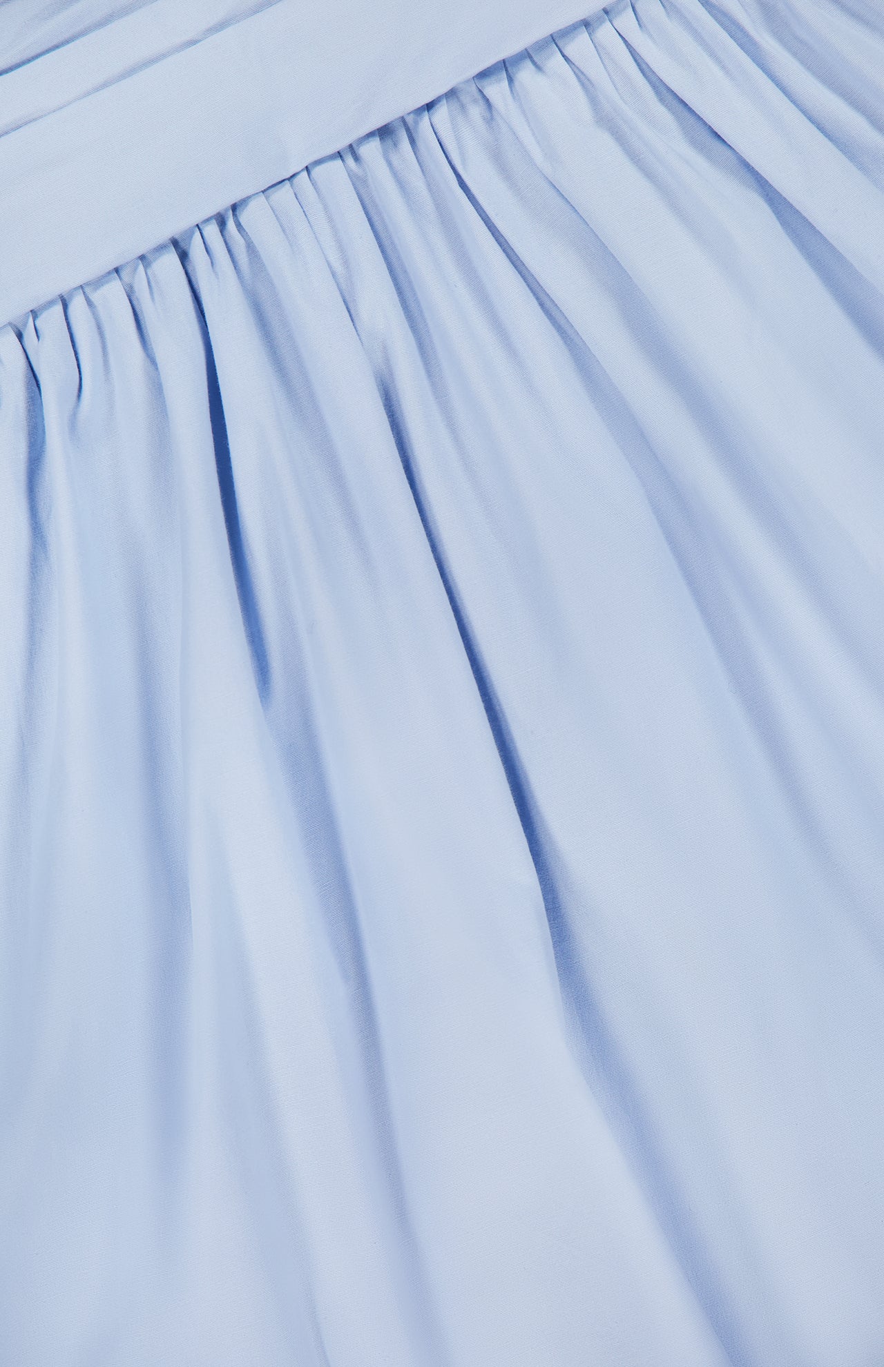 A close-up of light blue gathered pleats from the Agustina Open Back Maxi Dress by BAOBAB, highlighting its soft, flowing texture.