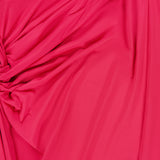 A close-up of bright pink, gathered and ruched fabric highlights the dynamic texture of BAOBAB's Canoa Knot Detail Maxi Dress in dark pink.