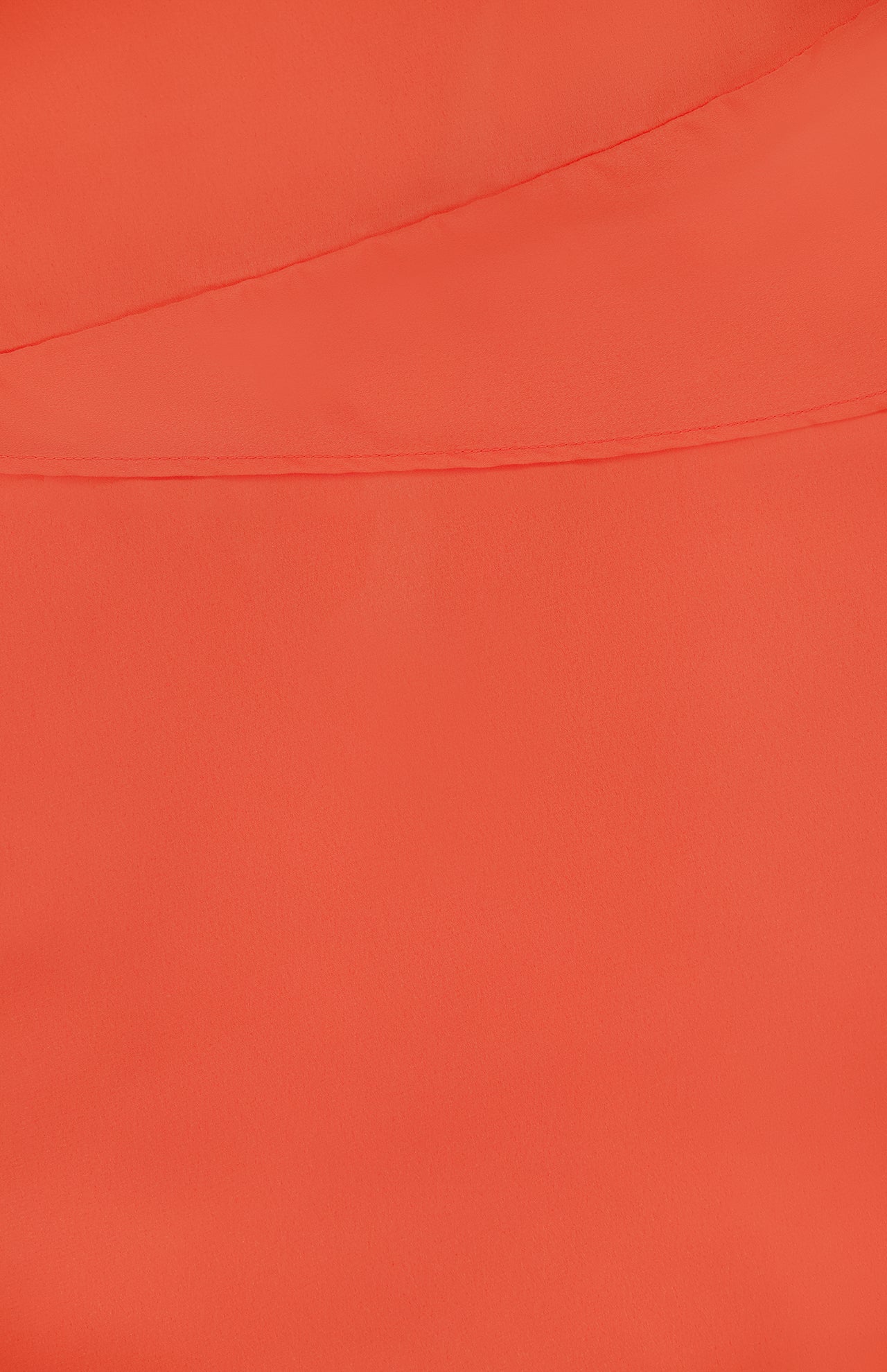 Close-up of the Lorenza Asymmetrical Mini Dress by BAOBAB shows its smooth, bright orange fabric and a diagonal seam across the upper part, highlighting the soft, slightly matte texture that reflects its chic cocktail style.