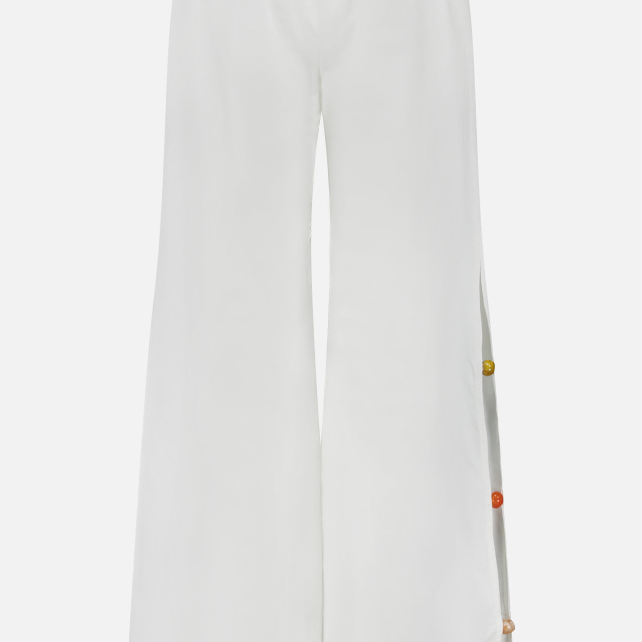 The Wayra Colorful Stones Pants by BAOBAB are high-rise, wide-leg white resort pants with an elastic waistband and multicolored buttons on the right seam, offering a relaxed fit and minimalist look for chic, effortless style.