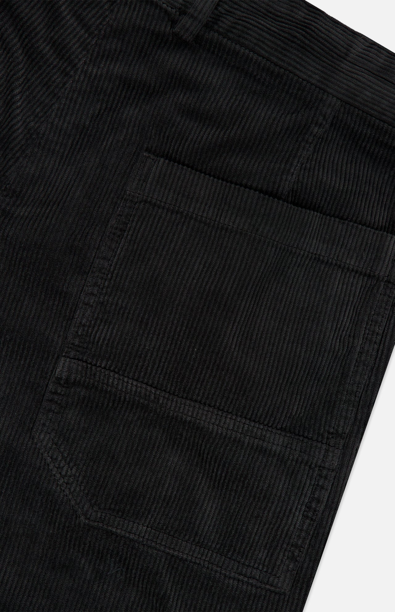 Close-up of a black corduroy fabric with a visible pocket, highlighting the texture and vertical ridges characteristic of corduroy material, as featured on the BARENA Cortivo Corduroy Pants made in Italy.