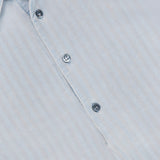 Close-up of the Desmo Button Up Long Sleeve Shirt by BARENA, made in Italy, in light blue cotton, highlighting part of the collar, three buttons, and subtle vertical stripes in the fabric.