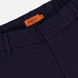 Close-up of Dosana Dandaro Pants by BARENA featuring a navy textured fabric, elastic waistband, belt loops, and an orange Barena Venezia label sewn inside. Premium quality design made in Italy.