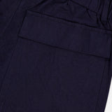 Close-up of BARENA Dosana Dandaro Pants in navy, made in Italy with slightly textured fabric. Features include an elastic waistband and a large side flap pocket, reflecting the brand's quality craftsmanship.