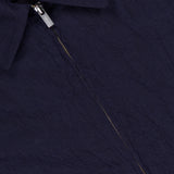 Close-up of the dark navy Marafon Dandaro Overshirt by BARENA, featuring a pointed collar and partially unzipped zipper that reveals an orange BARENA brand label. Expertly made in Italy for timeless style.