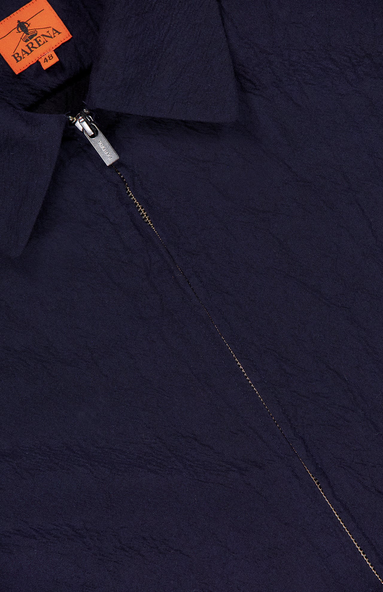 Close-up of the dark navy Marafon Dandaro Overshirt by BARENA, featuring a pointed collar and partially unzipped zipper that reveals an orange BARENA brand label. Expertly made in Italy for timeless style.