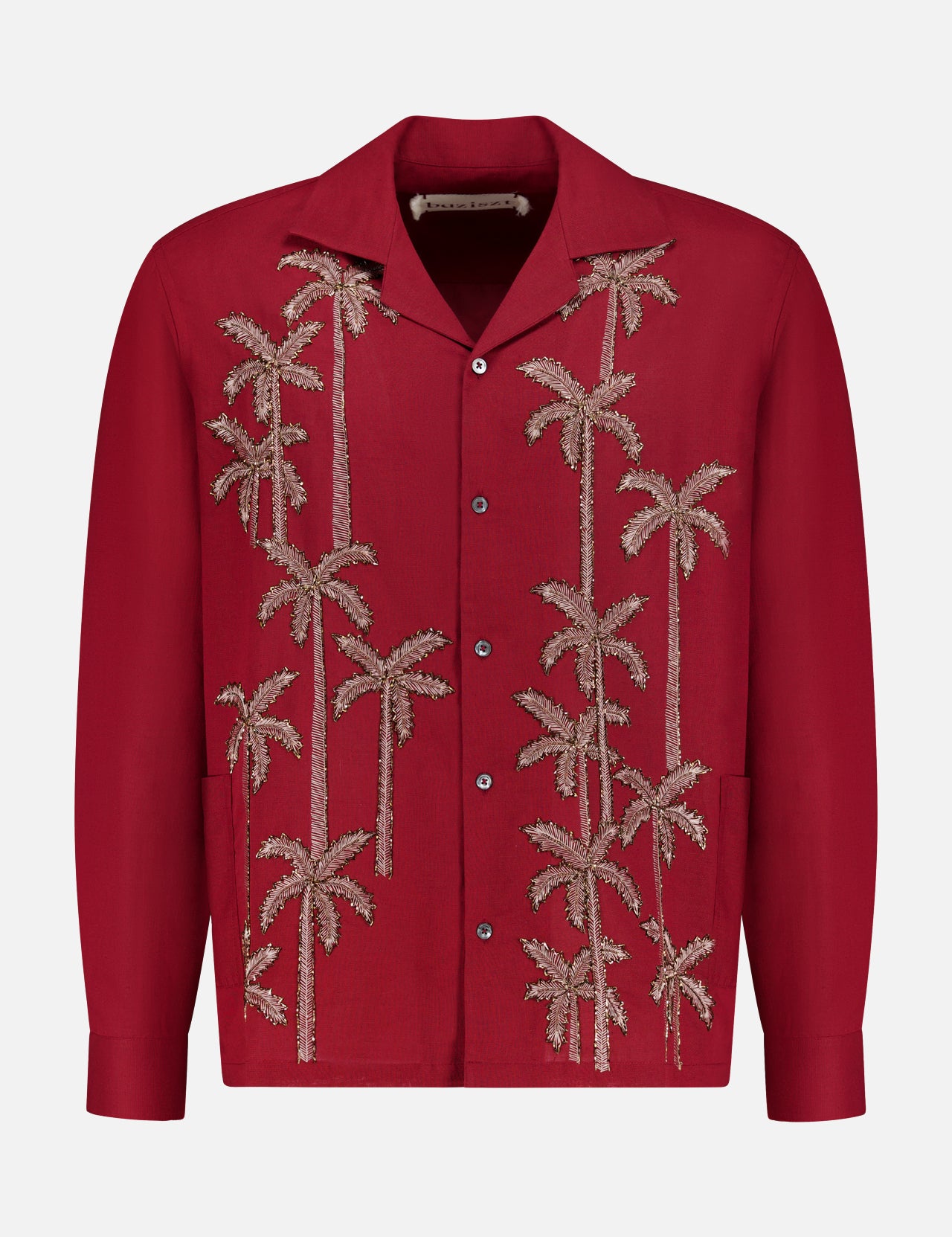 The Baziszt Palm Groove Embroidered Shirt is a vintage burgundy top with beige palm tree embroidery, a classic collar, and two front pockets.