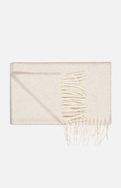 The Arran Reversible Scarf by BEGG & CO is a light beige unisex wool scarf with long fringe tassels at one end, shown folded on a plain white background.