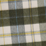 A close-up of the Arran Bennet Plaid Scarf by BEGG & CO showcases its dark green, white, and yellow intersecting lines and squares—an iconic plaid pattern crafted in cashmere for a classic Scottish accessory.